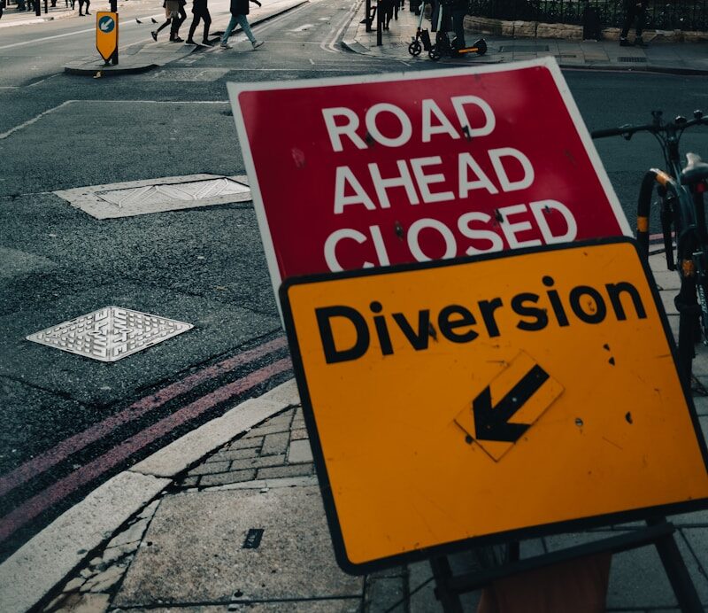 a road ahead closed sign on the side of the road